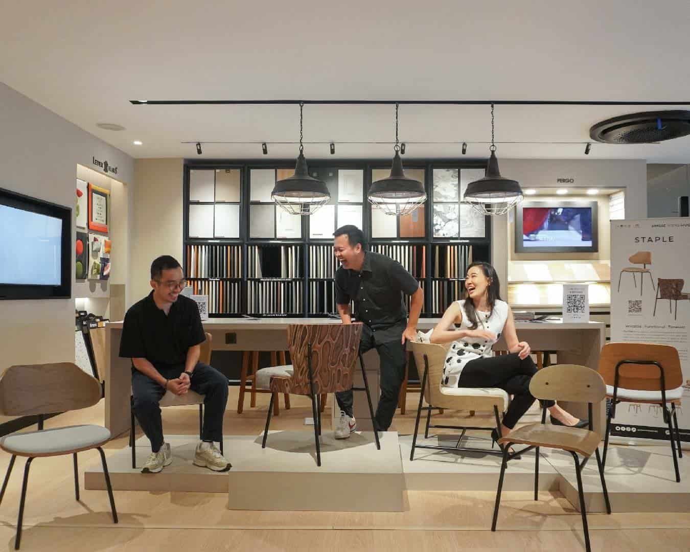 Panel Discussion: Three presenters at a counter in front of fabric swatches, smiling and engaged.