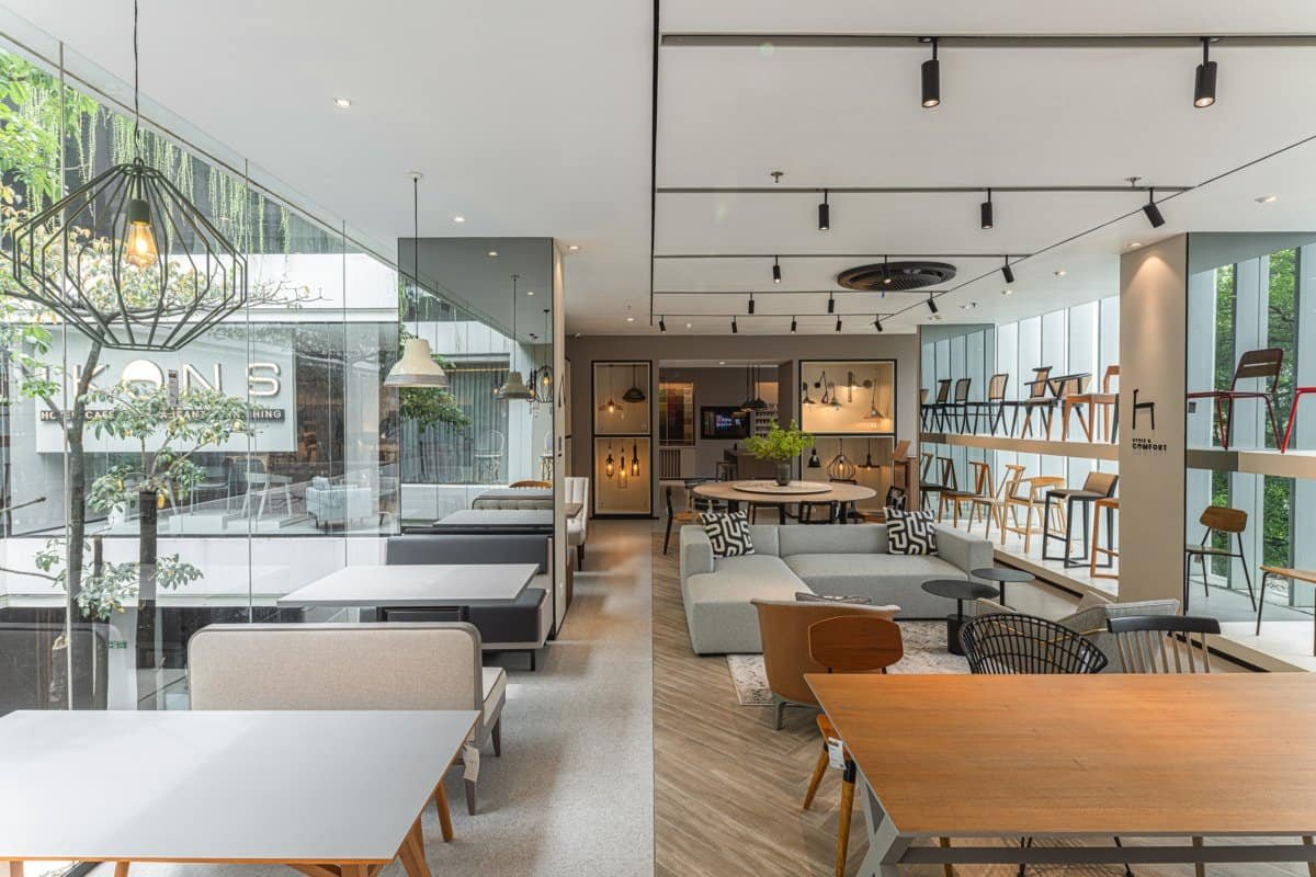 IKONS showroom with dining tables and chairs among plants